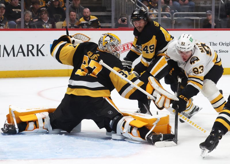 Mar 8, 2026; Pittsburgh, Pennsylvania, USA;  Pittsburgh Penguins goaltender Arturs Silovs (37) makes a save against Boston Bruins center Fraser Minten (93) during the third period at PPG Paints Arena. Mandatory Credit: Charles LeClaire-Imagn Images