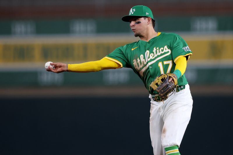 May 19, 2025; West Sacramento, California, USA; Athletics second baseman Luis Urias (17) throws to first for an out against the Los Angeles Angels during the eighth inning at Sutter Health Park. Mandatory Credit: Dennis Lee-Imagn Images