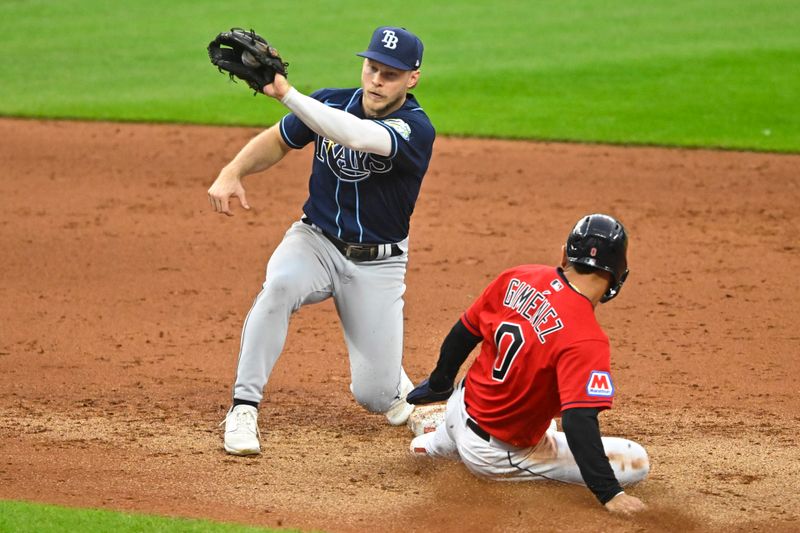 Sep 2, 2023; Cleveland, Ohio, USA; Cleveland Guardians second baseman Andres Gimenez (0) steals second base against Tampa Bay Rays shortstop Taylor Walls (6) in the fifth inning at Progressive Field. Mandatory Credit: David Richard-USA TODAY Sports