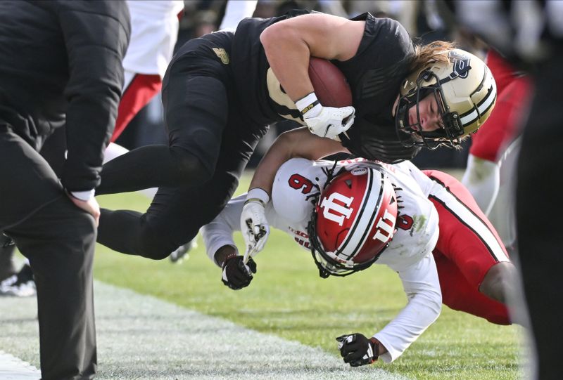 Nov 25, 2023; West Lafayette, Indiana, USA; Indiana Hoosiers defensive back Phillip Dunnam (6) tackles Purdue Boilermakers tight end George Burhenn (81) during the second half at Ross-Ade Stadium. Mandatory Credit: Robert Goddin-USA TODAY Sports