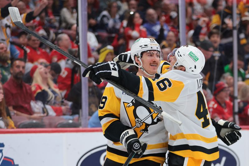 Oct 23, 2025; Sunrise, Florida, USA; Pittsburgh Penguins center Connor Dewar (19) celebrates with center Blake Lizotte (46) after scoring against the Florida Panthers during the second period at Amerant Bank Arena. Mandatory Credit: Sam Navarro-Imagn Images