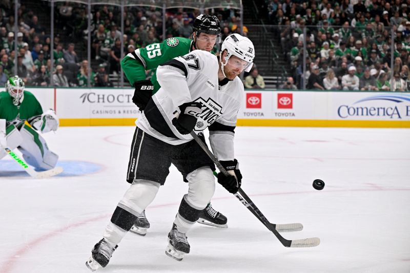 Oct 23, 2025; Dallas, Texas, USA; Dallas Stars defenseman Thomas Harley (55) and Los Angeles Kings left wing Warren Foegele (37) battle for control of the puck during the first period at the American Airlines Center. Mandatory Credit: Jerome Miron-Imagn Images