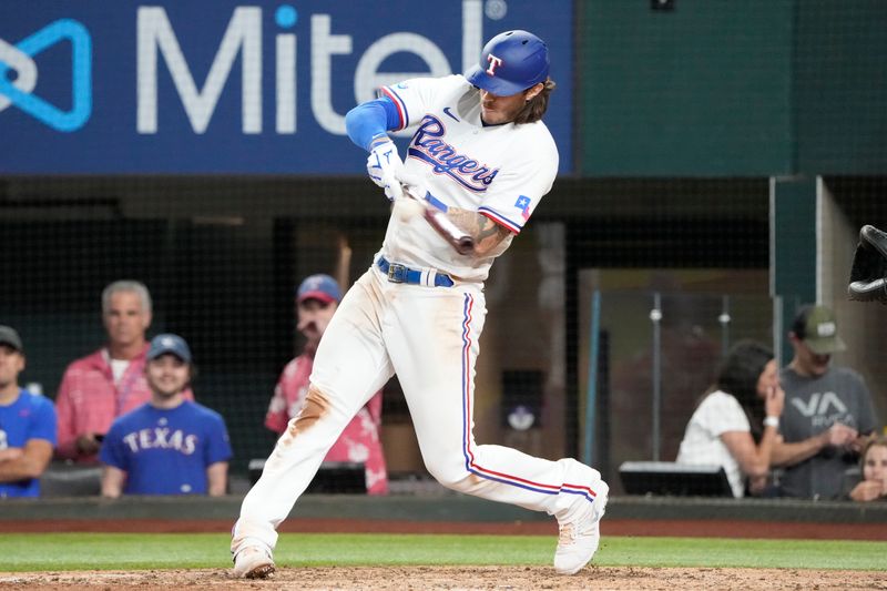 Apr 14, 2022; Arlington, Texas, USA; Texas Rangers catcher Jonah Heim (28) singles against the Los Angeles Angels during the fifth inning of a baseball game at Globe Life Field. Mandatory Credit: Jim Cowsert-USA TODAY Sports