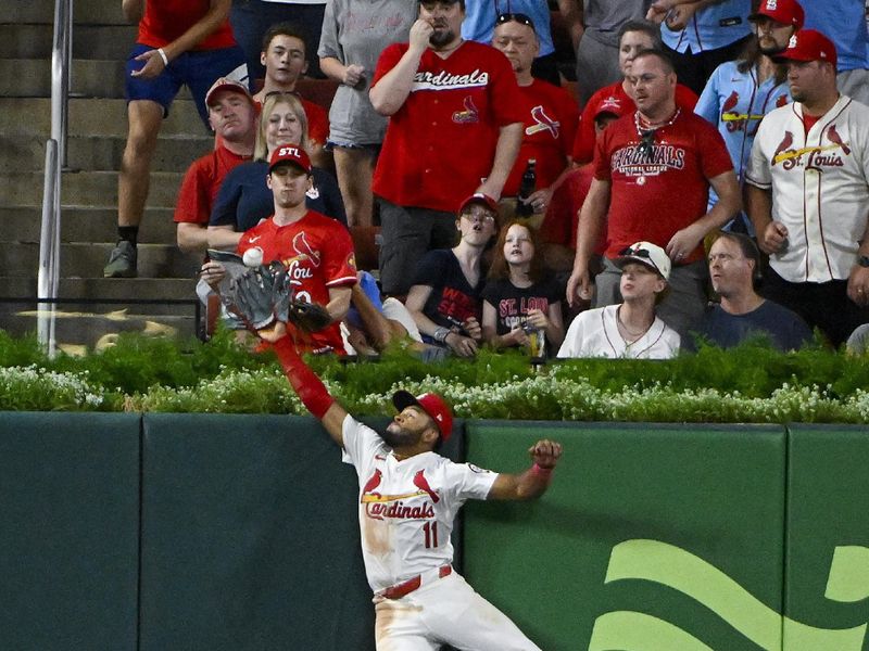 Aug 8, 2024; St. Louis, Missouri, USA;  St. Louis Cardinals center fielder Victor Scott II (11) leaps at the wall but is unable to catch a two run home run hit byTampa Bay Rays second baseman Brandon Lowe (not pictured) during the seventh inning at Busch Stadium. Mandatory Credit: Jeff Curry-USA TODAY Sports