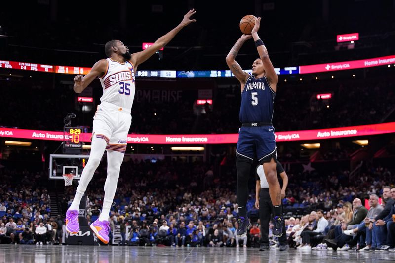 ORLANDO, FLORIDA - JANUARY 28: Paolo Banchero #5 of the Orlando Magic goes up for a shot against Kevin Durant #35 of the Phoenix Suns during the third quarter at Kia Center on January 28, 2024 in Orlando, Florida. NOTE TO USER: User expressly acknowledges and agrees that, by downloading and or using this photograph, User is consenting to the terms and conditions of the Getty Images License Agreement. (Photo by Rich Storry/Getty Images)