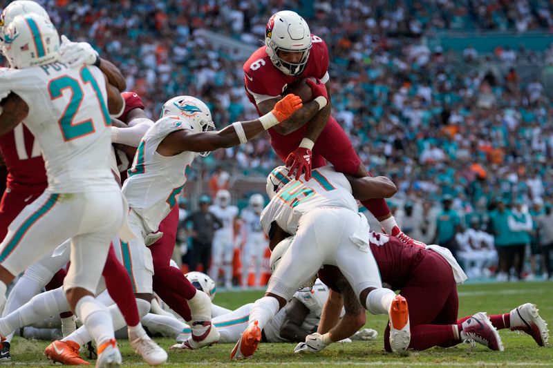 Miami Dolphins linebackers Tyus Bowser (51) and Jordyn Brooks (20) stop Arizona Cardinals running back James Conner's (6) attempt to score a two-point conversion during the second half of an NFL football game against the Miami Dolphins, Sunday, Oct. 27, 2024, in Miami Gardens, Fla. (AP Photo/Lynne Sladky)