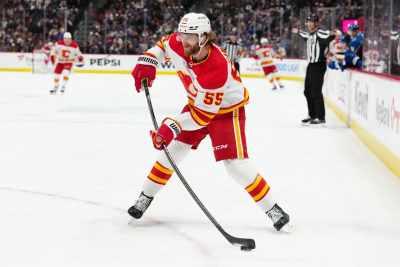 Dec 11, 2023; Denver, Colorado, USA; Calgary Flames defenseman Noah Hanifin (55) shoots the puck in the first period against the Colorado Avalanche at Ball Arena. Mandatory Credit: Ron Chenoy-USA TODAY Sports