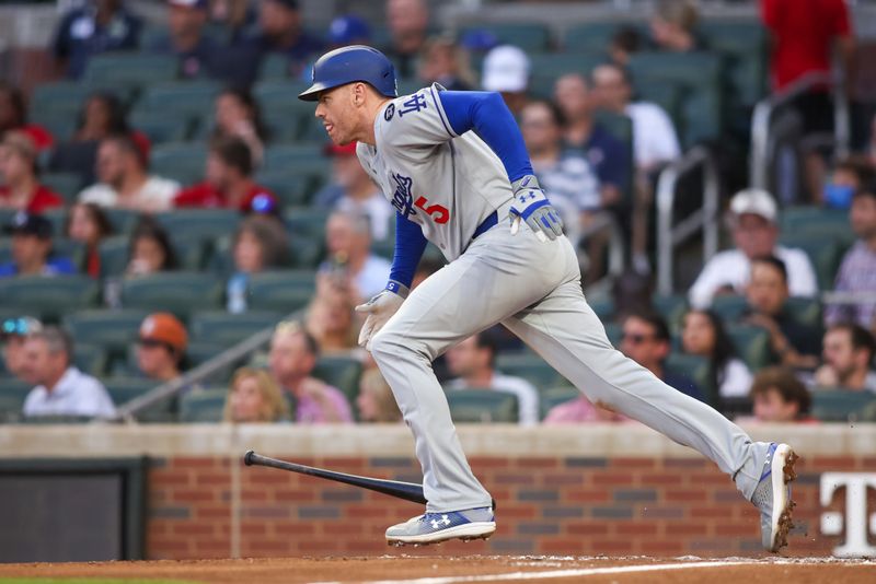 May 2, 2025; Atlanta, Georgia, USA; Los Angeles Dodgers first baseman Freddie Freeman (5) hits a single against the Atlanta Braves in the fourth inning at Truist Park. Mandatory Credit: Brett Davis-Imagn Images