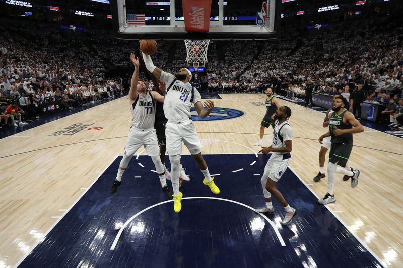 MINNEAPOLIS, MN - MAY 30: Daniel Gafford #21 of the Dallas Mavericks rebounds the ball during the game against the Minnesota Timberwolves during Game 5 of the Western Conference Finals of the 2024 NBA Playoffs on May 30, 2024 at Target Center in Minneapolis, Minnesota. NOTE TO USER: User expressly acknowledges and agrees that, by downloading and or using this Photograph, user is consenting to the terms and conditions of the Getty Images License Agreement. Mandatory Copyright Notice: Copyright 2024 NBAE (Photo by Jordan Johnson/NBAE via Getty Images)