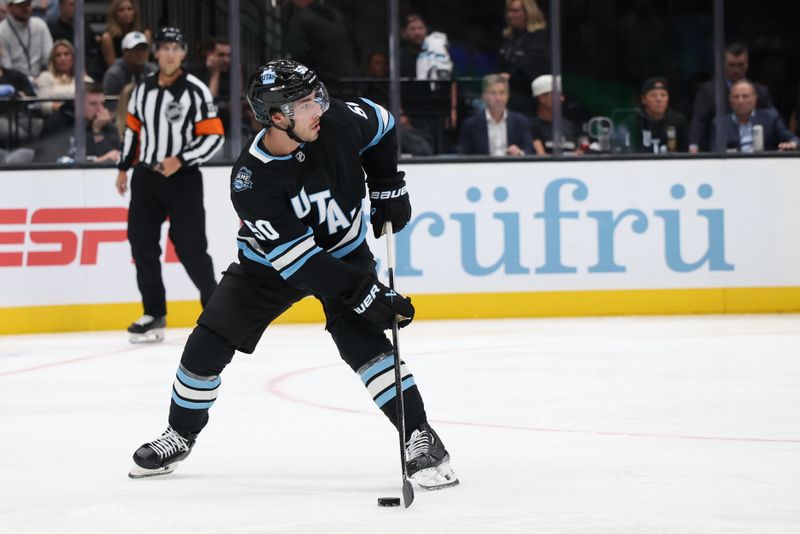 Oct 8, 2024; Salt Lake City, Utah, USA; Utah Hockey Club defenseman Sean Durzi (50) looks to pass against the Chicago Blackhawks during the third period at Delta Center. Mandatory Credit: Rob Gray-Imagn Images