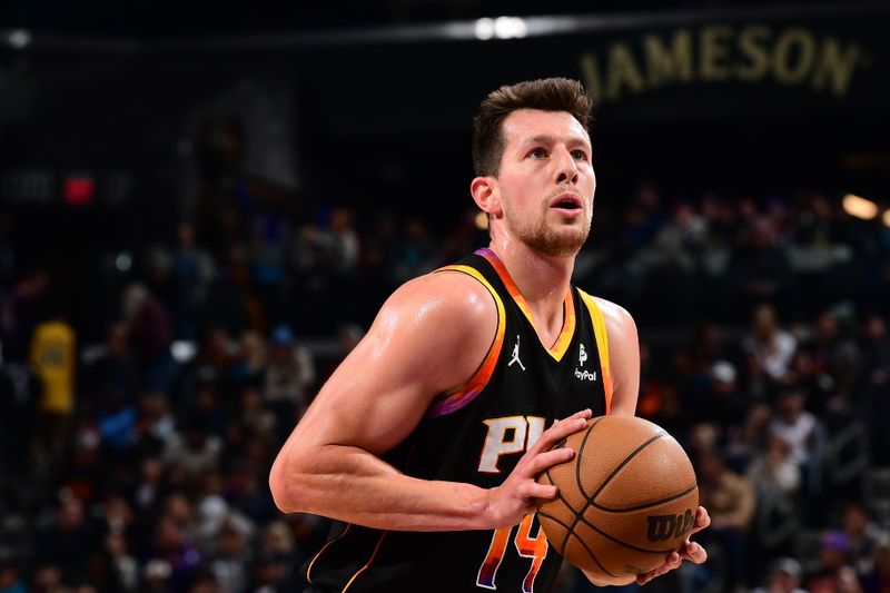 PHOENIX, AZ - FEBRUARY 8:  Drew Eubanks #14 of the Phoenix Suns shoots a free throw during the game on February 8, 2024 at Footprint Center in Phoenix, Arizona. NOTE TO USER: User expressly acknowledges and agrees that, by downloading and or using this photograph, user is consenting to the terms and conditions of the Getty Images License Agreement. Mandatory Copyright Notice: Copyright 2024 NBAE (Photo by Kate Frese/NBAE via Getty Images)