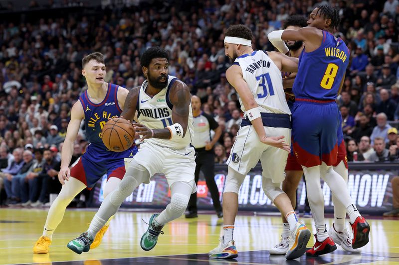 DENVER, COLORADO - NOVEMBER 22: Kyrie Irving #11 of the Dallas Mavericks drives against Christian Braun #0 of the Denver Nuggets in the first quarter of the Emirates NBA Cup at Ball Arena on November 22, 2024 in Denver, Colorado. NOTE TO USER: User expressly acknowledges and agrees that, by downloading and or using this photograph, User is consenting to the terms and conditions of the Getty Images License Agreement.  (Photo by Matthew Stockman/Getty Images)