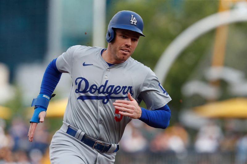 Jun 4, 2024; Pittsburgh, Pennsylvania, USA;  Los Angeles Dodgers first baseman Freddie Freeman (5) runs from first base to third base against the Pittsburgh Pirates during the first inning at PNC Park. Mandatory Credit: Charles LeClaire-USA TODAY Sports