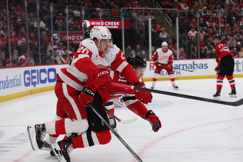 Mar 8, 2026; Newark, New Jersey, USA;  Detroit Red Wings defenseman Albert Johansson (20) and New Jersey Devils right wing Arseny Gritsyuk (81) go for the puck during the first period at Prudential Center. Mandatory Credit: Thomas Salus-Imagn Images