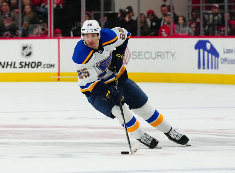 Jan 6, 2024; Raleigh, North Carolina, USA; St. Louis Blues center Jordan Kyrou (25) skates with the puck against the Carolina Hurricanes during the second period at PNC Arena. Mandatory Credit: James Guillory-USA TODAY Sports