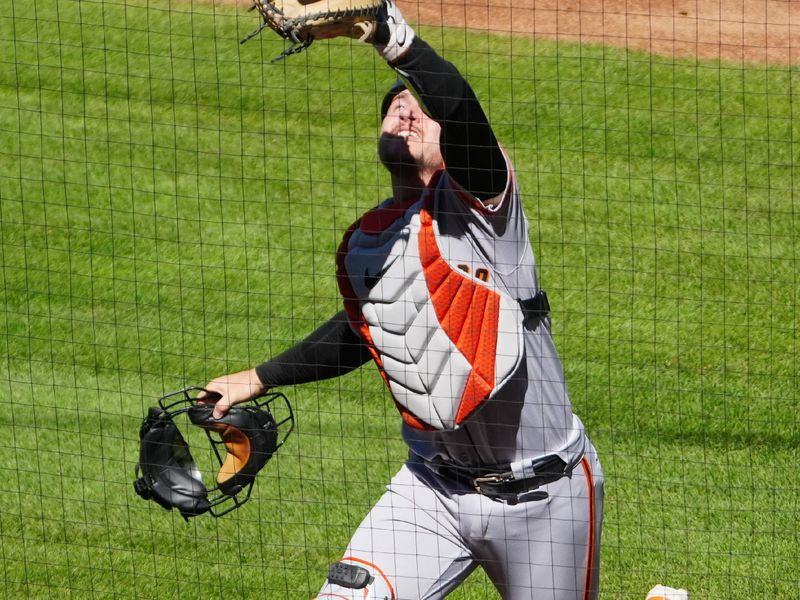 Sep 17, 2023; Denver, Colorado, USA;  San Francisco Giants catcher Patrick Bailey (14) fields the ball in the sixth inning against the Colorado Rockies at Coors Field. Mandatory Credit: Ron Chenoy-USA TODAY Sports