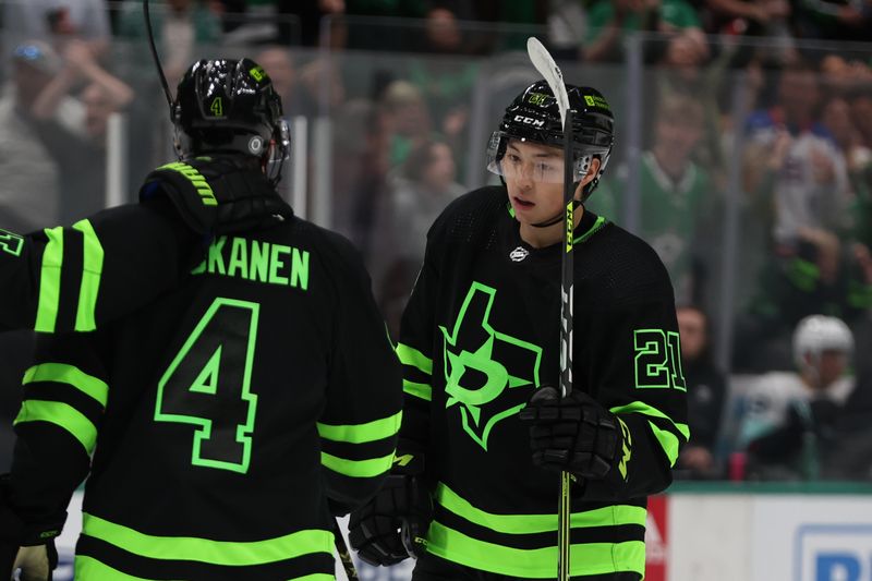 Apr 13, 2024; Dallas, Texas, USA; Dallas Stars left wing Jason Robertson (21) and defenseman Miro Heiskanen (4) celebrate a power play goal against the Seattle Kraken in the second period at American Airlines Center. Mandatory Credit: Tim Heitman-USA TODAY Sports