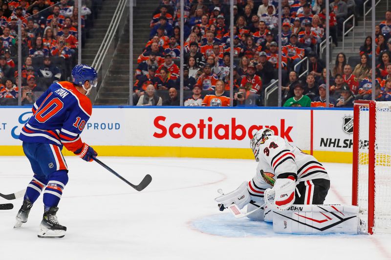 Oct 12, 2024; Edmonton, Alberta, CAN; Chicago Blackhawks goaltender Petr Mrazek (34) makes a save on Edmonton Oilers forward Derek Ryan (10)during the first period at Rogers Place. Mandatory Credit: Perry Nelson-Imagn Images