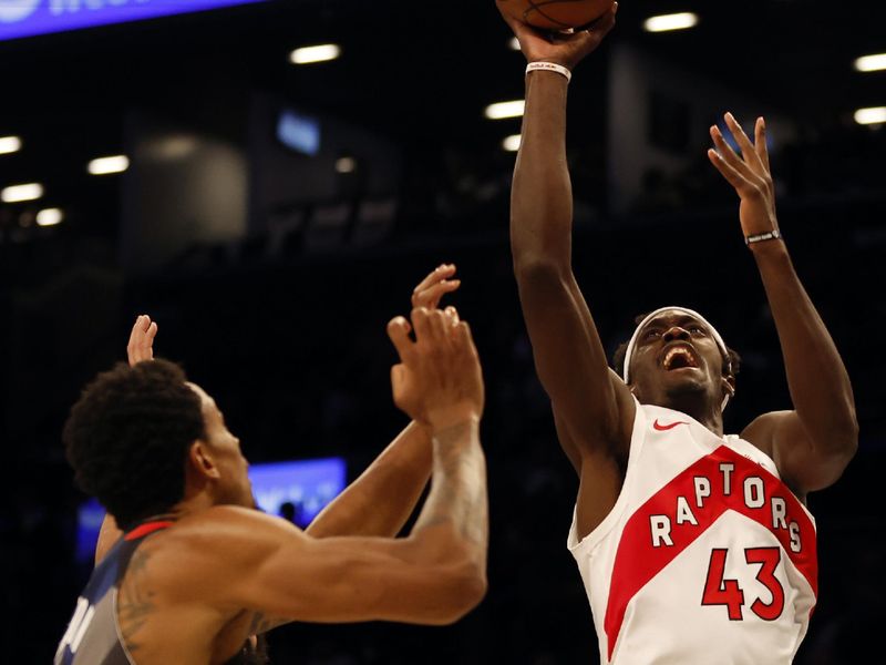 NEW YORK, NEW YORK - NOVEMBER 28: Pascal Siakam #43 of the Toronto Raptors goes to the basket as Nic Claxton #33 and Spencer Dinwiddie #26 of the Brooklyn Nets defend during the first half of an NBA In-Season Tournament game at Barclays Center on November 28, 2023 in the Brooklyn borough of New York City. NOTE TO USER: User expressly acknowledges and agrees that, by downloading and/or using this photograph, User is consenting to the terms and conditions of the Getty Images License Agreement. (Photo by Sarah Stier/Getty Images)