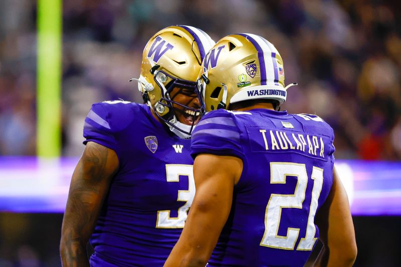 Sep 24, 2022; Seattle, Washington, USA; Washington Huskies running back Wayne Taulapapa (21) celebrates with Washington Huskies linebacker Cam Bright (2) after rushing for a touchdown against the Stanford Cardinal during the second quarter at Alaska Airlines Field at Husky Stadium. Mandatory Credit: Joe Nicholson-USA TODAY Sports