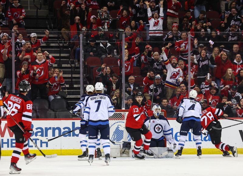 Mar 21, 2024; Newark, New Jersey, USA; New Jersey Devils center Jack Hughes (86) scores a goal against the Winnipeg Jets during the third period at Prudential Center. Mandatory Credit: Ed Mulholland-USA TODAY Sports