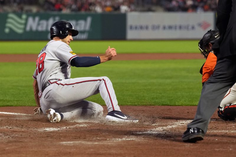 Aug 25, 2023; San Francisco, California, USA; Atlanta Braves first baseman Matt Olson (28) slides into home plate to score a run against the San Francisco Giants during the fourth inning at Oracle Park. Mandatory Credit: Darren Yamashita-USA TODAY Sports