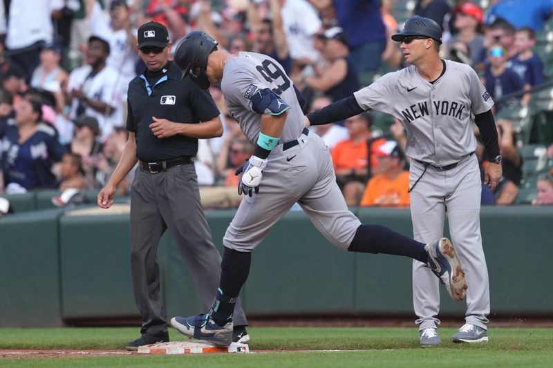 Jul 13, 2024; Baltimore, Maryland, USA; New York Yankees outfielder Aaron Judge (left) greeted by coach Travis Chapman (right) following his solo home run in the fifth inning against the Baltimore Orioles at Oriole Park at Camden Yards. Mandatory Credit: Mitch Stringer-USA TODAY Sports