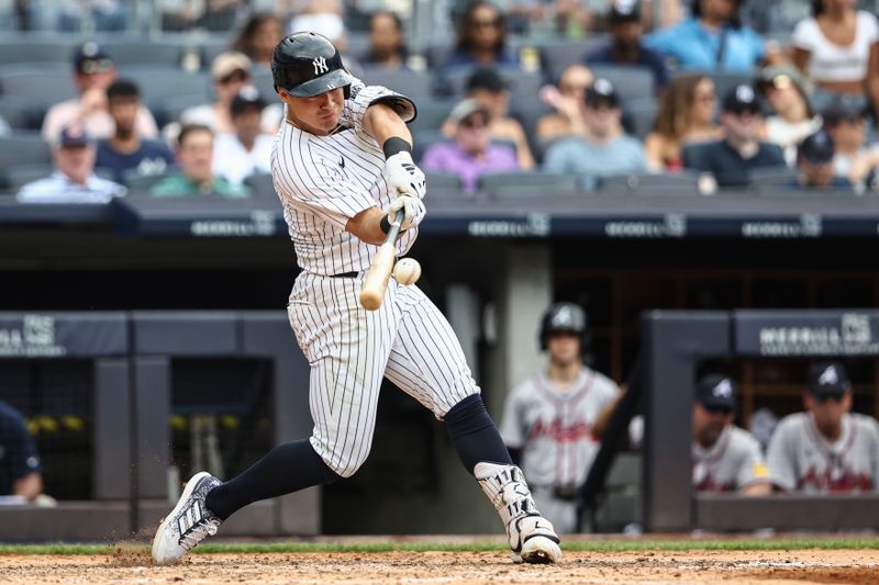 Jun 23, 2024; Bronx, New York, USA;  New York Yankees shortstop Anthony Volpe (11) hits an RBI double in the sixth inning against the Atlanta Braves at Yankee Stadium. Mandatory Credit: Wendell Cruz-USA TODAY Sports