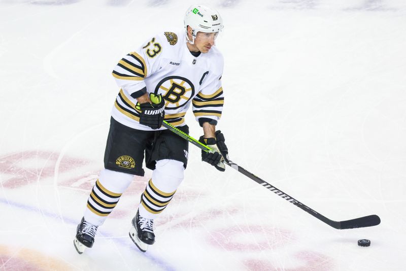 Feb 22, 2024; Calgary, Alberta, CAN; Boston Bruins left wing Brad Marchand (63) skates with the puck during the warmup period against the Calgary Flames at Scotiabank Saddledome. Mandatory Credit: Sergei Belski-USA TODAY Sports