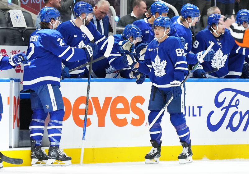 Oct 12, 2024; Toronto, Ontario, CAN; Toronto Maple Leafs right wing William Nylander (88) celebrates at the bench after scoring a goal  against the Pittsburgh Penguins during the second period at Scotiabank Arena. Mandatory Credit: Nick Turchiaro-Imagn Images