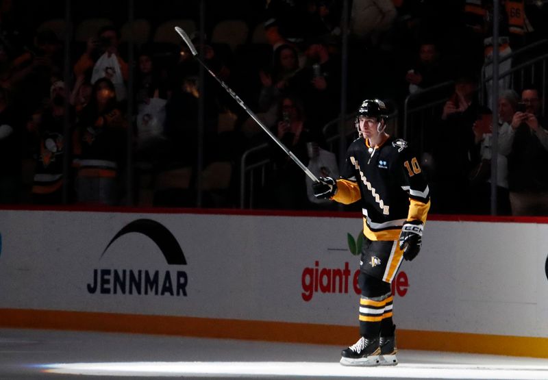 Mar 14, 2024; Pittsburgh, Pennsylvania, USA; Pittsburgh Penguins left wing Drew O'Connor (10) waves to the crowd after being named a star of the game against the San Jose Sharks at PPG Paints Arena. Pittsburgh won 6-3. Mandatory Credit: Charles LeClaire-USA TODAY Sports