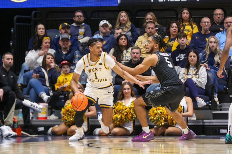 Jan 17, 2026; Morgantown, West Virginia, USA; West Virginia Mountaineers guard Jasper Floyd (1) dribbles against Colorado Buffaloes guard Josiah Sanders (5) during the first half at Hope Coliseum. Mandatory Credit: Ben Queen-Imagn Images