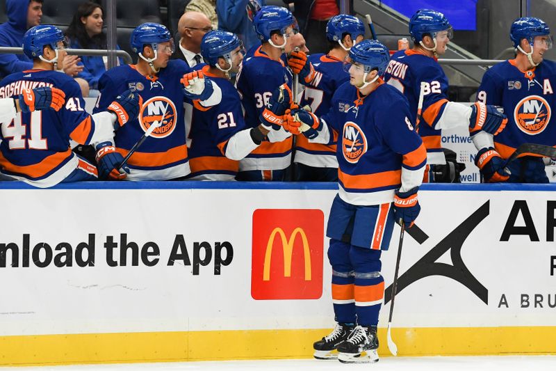Oct 6, 2022; Elmont, New York, USA; New York Islanders defenseman Noah Dobson (8) is congratulated after scoring a goal against the New Jersey Devils during the first period at UBS Arena. Mandatory Credit: Dennis Schneidler-USA TODAY Sports