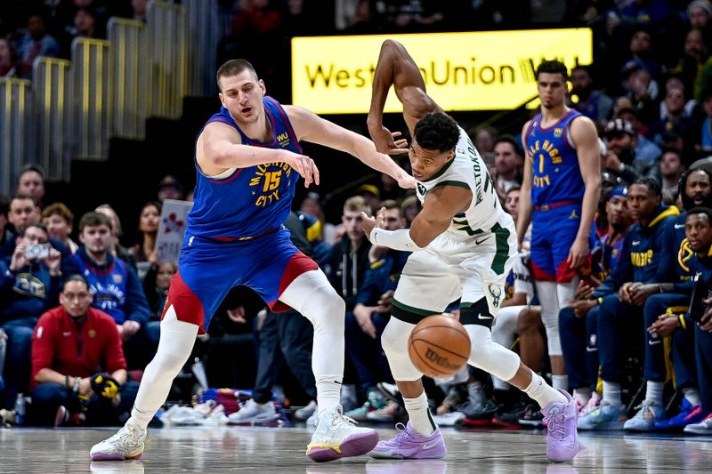 DENVER, CO - MARCH 25:  Giannis Antetokounmpo #34 of the Milwaukee Bucks steals the ball from Nikola Jokic #15 of the Denver Nuggets in the second half of a game at Ball Arena on March 25, 2023 in Denver, Colorado. NOTE TO USER: User expressly acknowledges and agrees that, by downloading and or using this photograph, User is consenting to the terms and conditions of the Getty Images License Agreement. (Photo by Dustin Bradford/Getty Images)