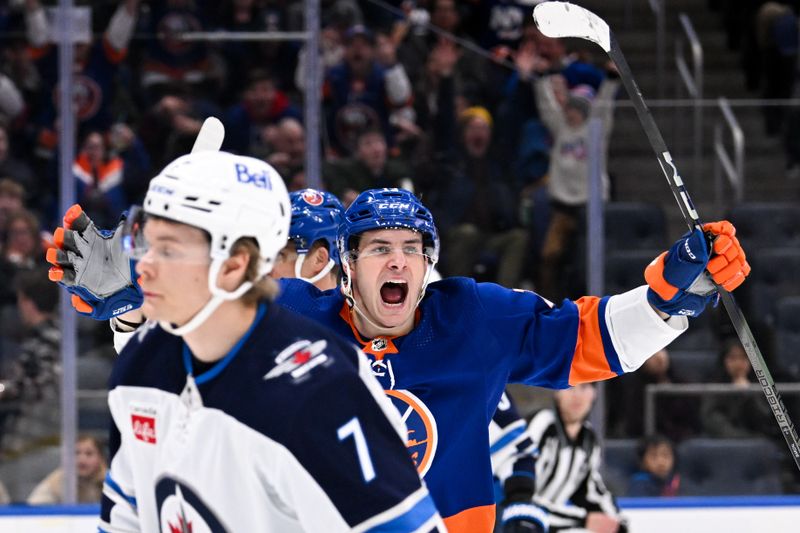 Mar 23, 2024; Elmont, New York, USA;  New York Islanders center Mathew Barzal (13) celebrates his assist against the Winnipeg Jets during the second period at UBS Arena. Mandatory Credit: Dennis Schneidler-USA TODAY Sports