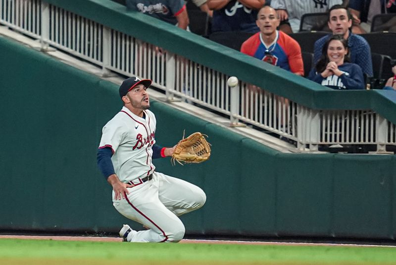 Aug 20, 2024; Cumberland, Georgia, USA; Atlanta Braves right fielder Ramon Laureano (18) makes a sliding catch on a ball hit by Philadelphia Phillies right fielder Nick Castellanos (8) (not shown) during the ninth inning at Truist Park. Mandatory Credit: Dale Zanine-USA TODAY Sports