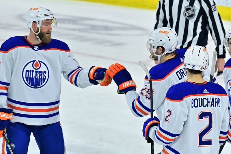 Mar 27, 2023; Tempe, Arizona, USA;  Edmonton Oilers center Leon Draisaitl (29) celebrates with defenseman Evan Bouchard (2) and defenseman Mattias Ekholm (14) after scoring a goal in the second period against the Arizona Coyotes at Mullett Arena. Mandatory Credit: Matt Kartozian-USA TODAY Sports