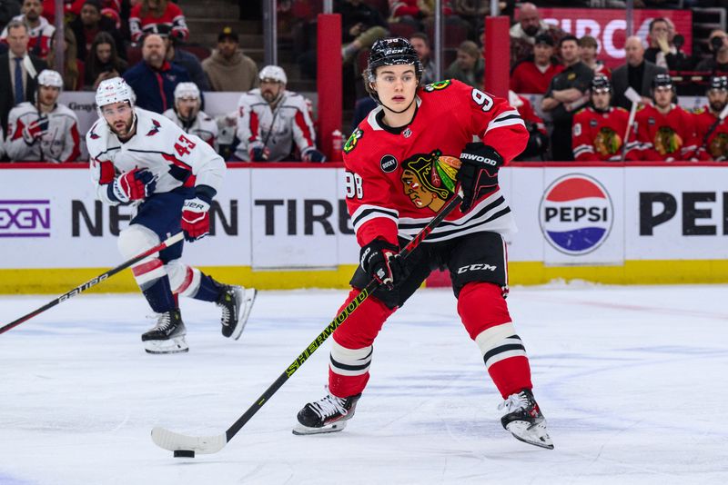 Dec 10, 2023; Chicago, Illinois, USA; Chicago Blackhawks center Connor Bedard (98) passes the puck against the Washington Capitals during the first period at the United Center. Mandatory Credit: Daniel Bartel-USA TODAY Sports