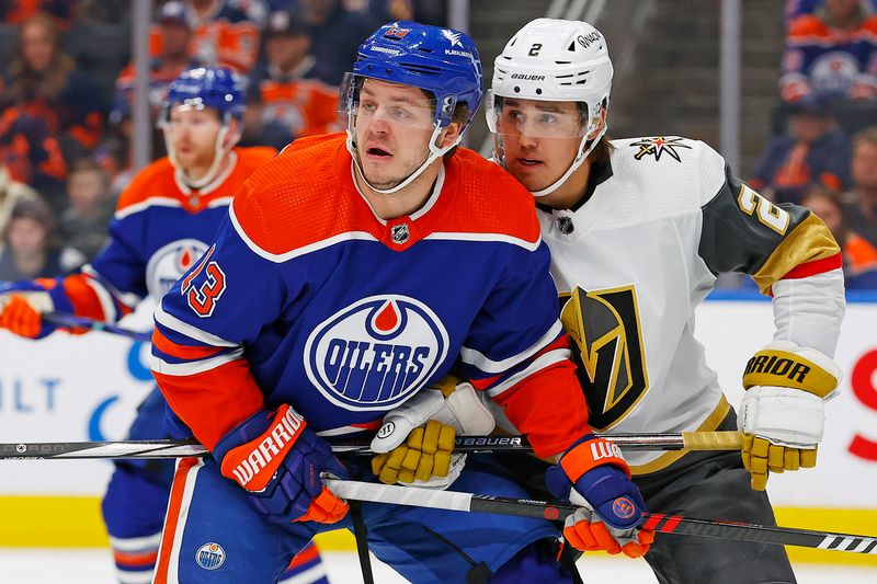 Apr 10, 2024; Edmonton, Alberta, CAN; Edmonton Oilers forward Mattias Janmark (13) and Vegas Golden Knights defensemen Zach Whitecloud (2) battle for position during the first period at Rogers Place. Mandatory Credit: Perry Nelson-USA TODAY Sports