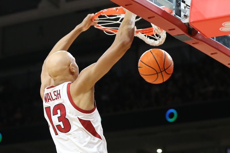 Feb 11, 2023; Fayetteville, Arkansas, USA; Arkansas Razorbacks guard Jordan Walsh (13) dunks the ball against the Mississippi State Bulldogs during the first half at Bud Walton Arena. Mandatory Credit: Nelson Chenault-USA TODAY Sports