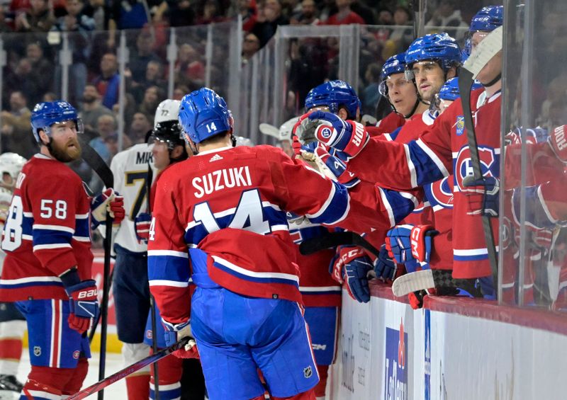 Apr 2, 2024; Montreal, Quebec, CAN; Montreal Canadiens forward Nick Suzuki (14) celebrates with teammates after scoring a goal against the Florida Panthers during the second period at the Bell Centre. Mandatory Credit: Eric Bolte-USA TODAY Sports