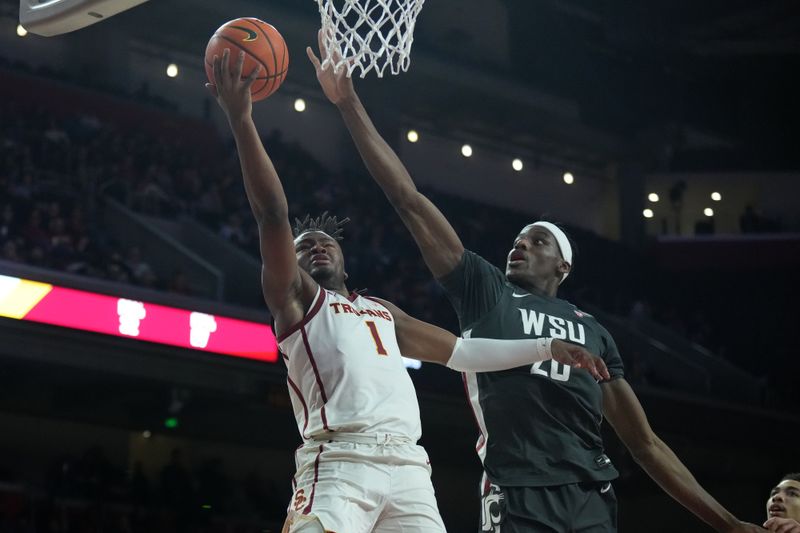 Jan 10, 2024; Los Angeles, California, USA; Southern California Trojans guard Isaiah Collier (1) shoots the ball against Washington State Cougars center Rueben Chinyelu (20) in the second half at Galen Center. Mandatory Credit: Kirby Lee-USA TODAY Sports