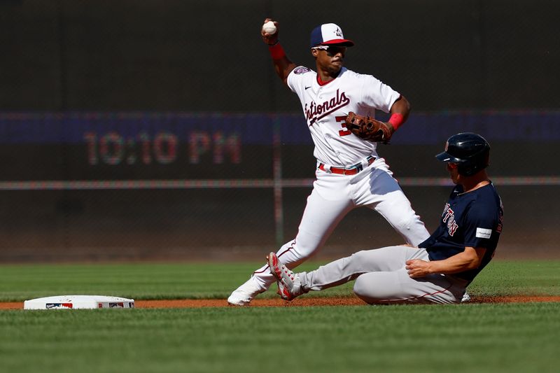 Aug 17, 2023; Washington, District of Columbia, USA; Washington Nationals second baseman Jeter Downs (3) attempts to turn a double play at second base ahead of a slide by Boston Red Sox left fielder Rob Refsnyder (30) during the first inning at Nationals Park. Mandatory Credit: Geoff Burke-USA TODAY Sports