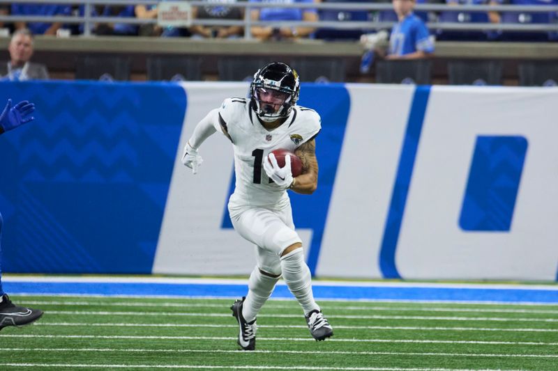 Jacksonville Jaguars wide receiver Parker Washington (11) runs the ball against the Detroit Lions during an NFL pre-season football game, Saturday, Aug. 19, 2023, in Detroit. (AP Photo/Rick Osentoski)