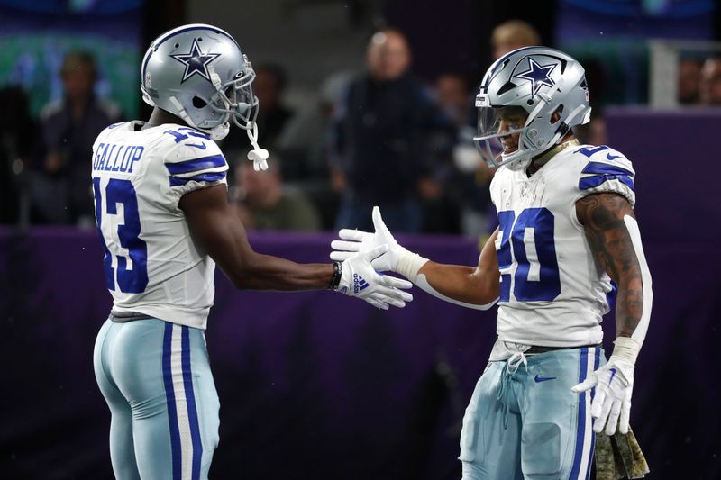 Dallas Cowboys running back Tony Pollard celebrates with teammate wide receiver Michael Gallup (13) after catching a 68-yard touchdown pass in the second half of an NFL football game against the Minnesota Vikings, Sunday, Nov. 20, 2022, in Minneapolis. (AP Photo/Bruce Kluckhohn)