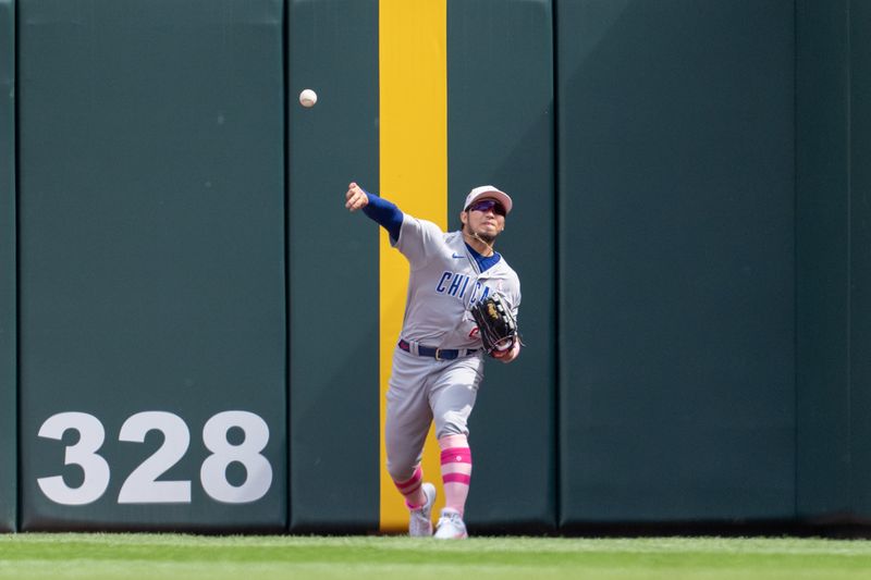 May 14, 2023; Minneapolis, Minnesota, USA; Chicago Cubs right fielder Seiya Suzuki (27) throws the ball to the infield after Minnesota Twins second baseman Jorge Polanco (11) hits a double in the eighth inning at Target Field. Mandatory Credit: Matt Blewett-USA TODAY Sports