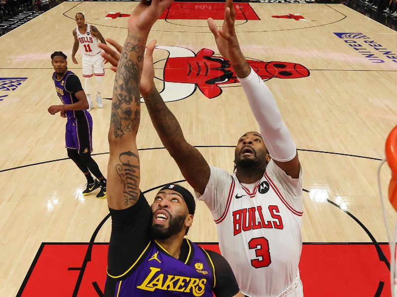 CHICAGO, ILLINOIS - DECEMBER 20: Anthony Davis #3 of the Los Angeles Lakers and Andre Drummond #3 of the Chicago Bulls battle for a rebound during the second half at the United Center on December 20, 2023 in Chicago, Illinois. NOTE TO USER: User expressly acknowledges and agrees that, by downloading and or using this photograph, User is consenting to the terms and conditions of the Getty Images License Agreement.  (Photo by Michael Reaves/Getty Images)