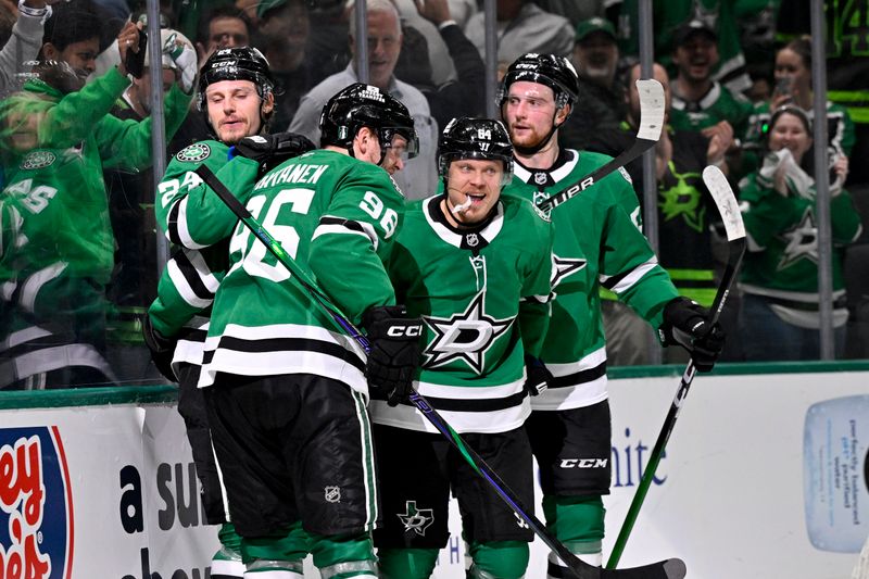 May 13, 2025; Dallas, Texas, USA; Dallas Stars right wing Mikko Rantanen (96) and center Roope Hintz (24) and center Mikael Granlund (64) and defenseman Thomas Harley (55) celebrates a goal scored by Granlund against the Winnipeg Jets during the second period in game four of the second round of the 2025 Stanley Cup Playoffs at American Airlines Center. Mandatory Credit: Jerome Miron-Imagn Images