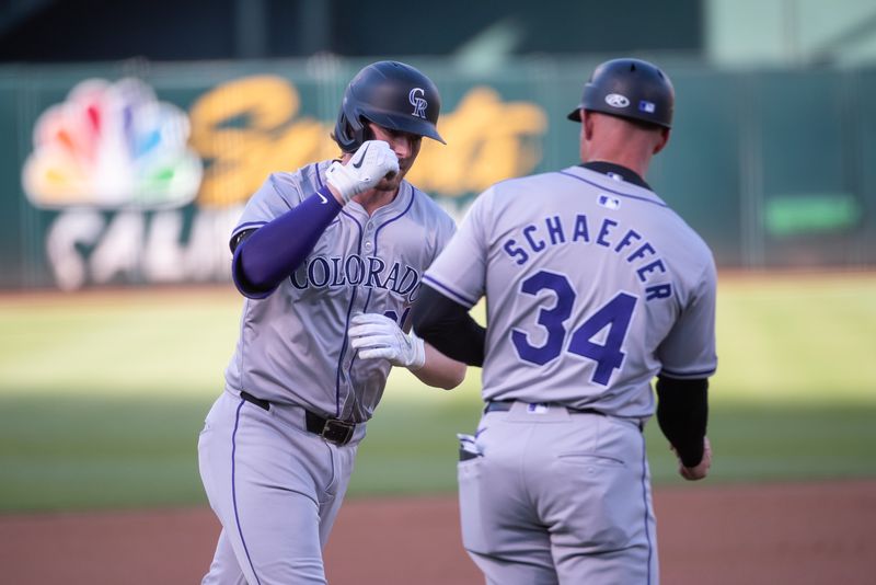 May 21, 2024; Oakland, California, USA; Colorado Rockies third base Ryan McMahon (24) celebrates with third base coach/infield coach Warren Schaeffer (34) after hitting a home run during the first inning at Oakland-Alameda County Coliseum. Mandatory Credit: Ed Szczepanski-USA TODAY Sports