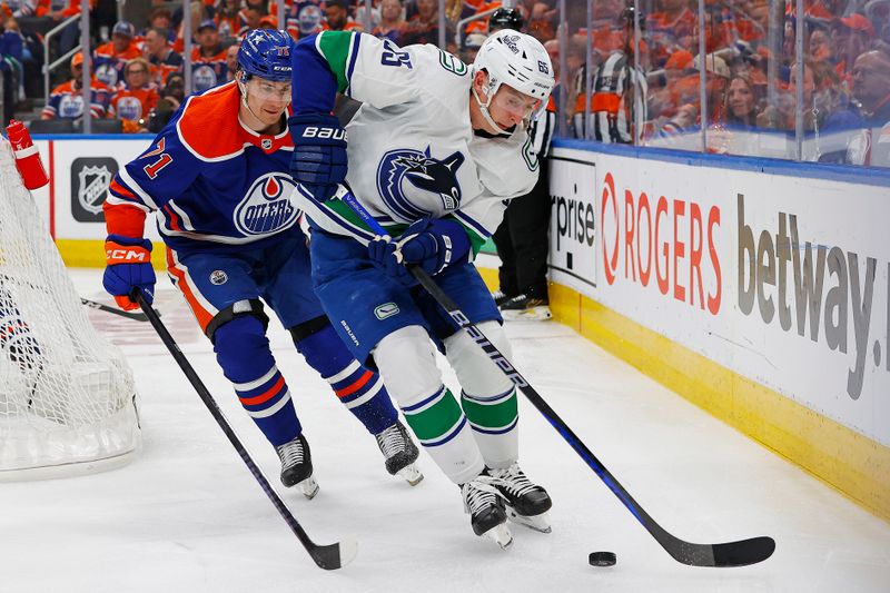 May 12, 2024; Edmonton, Alberta, CAN; .z65/ protects the puck from Edmonton Oilers forward Ryan McLeod (71) during the second period in game three of the second round of the 2024 Stanley Cup Playoffs at Rogers Place. Mandatory Credit: Perry Nelson-USA TODAY Sports